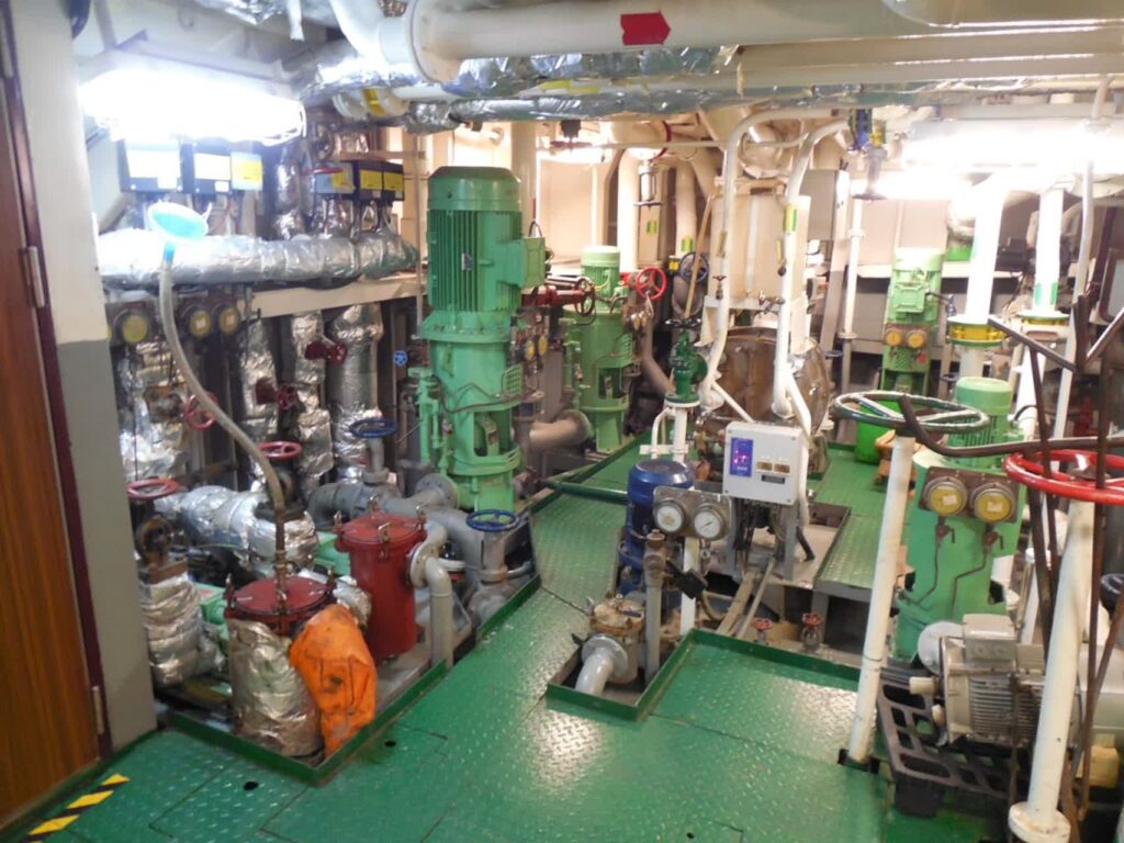 Ship engine room with machinery piping platforms and maintenance access