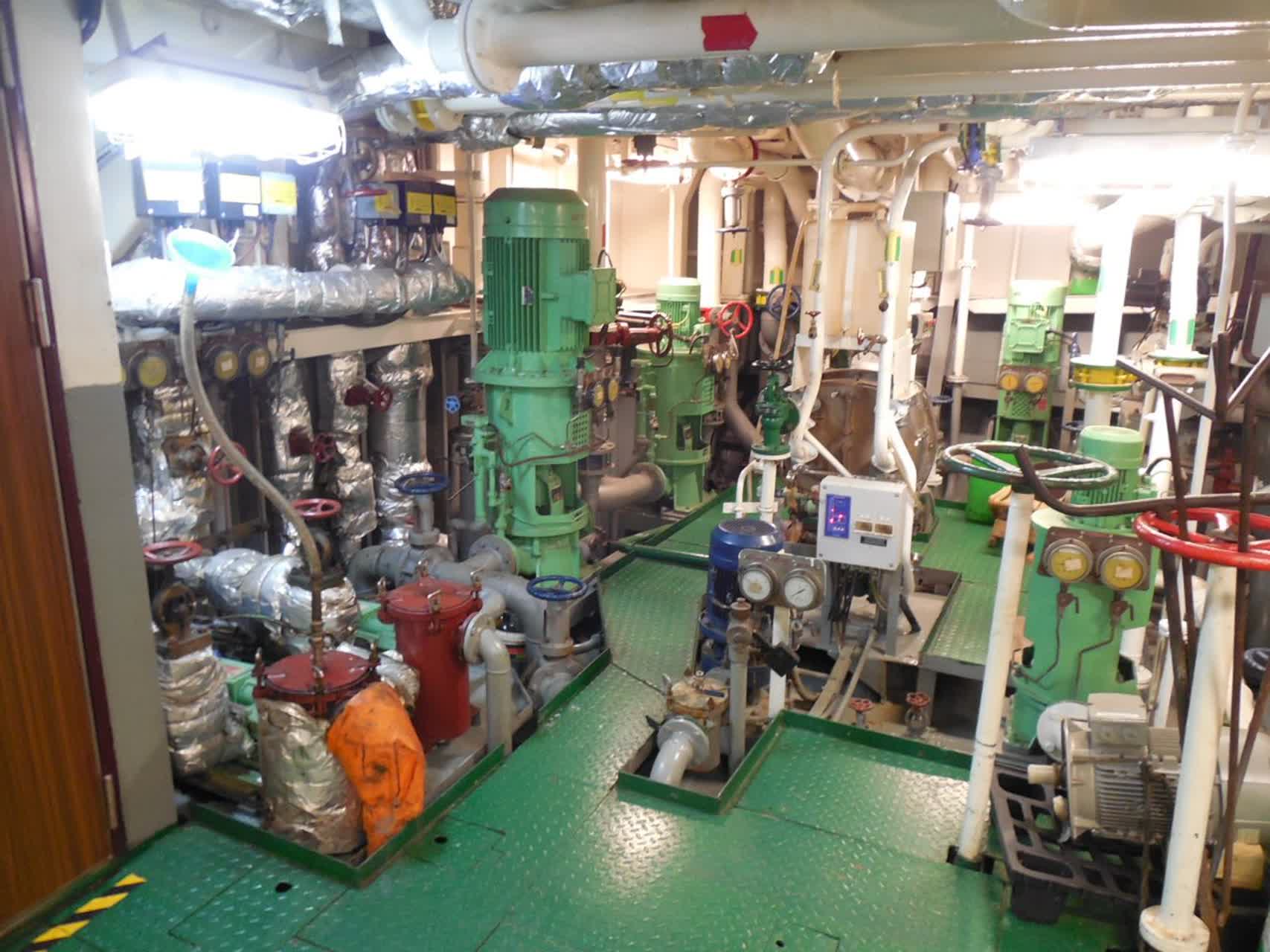 Ship engine room with machinery, piping, platforms, and maintenance access