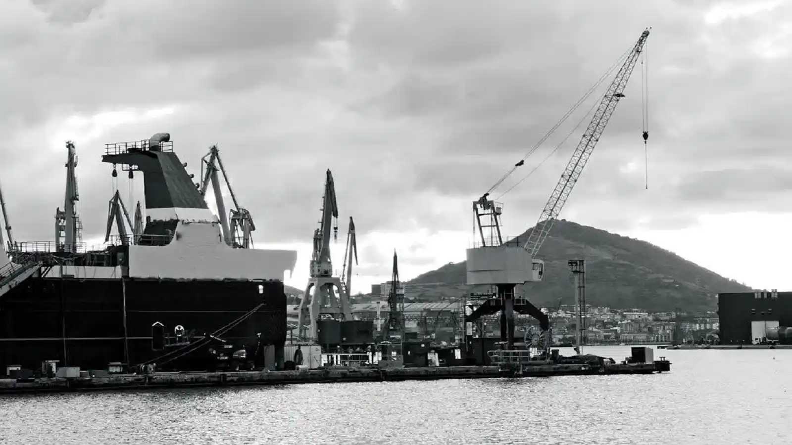 Industrial harbor with vessel and cranes illustrating Support Ocean Tech Review and marine engineering development
