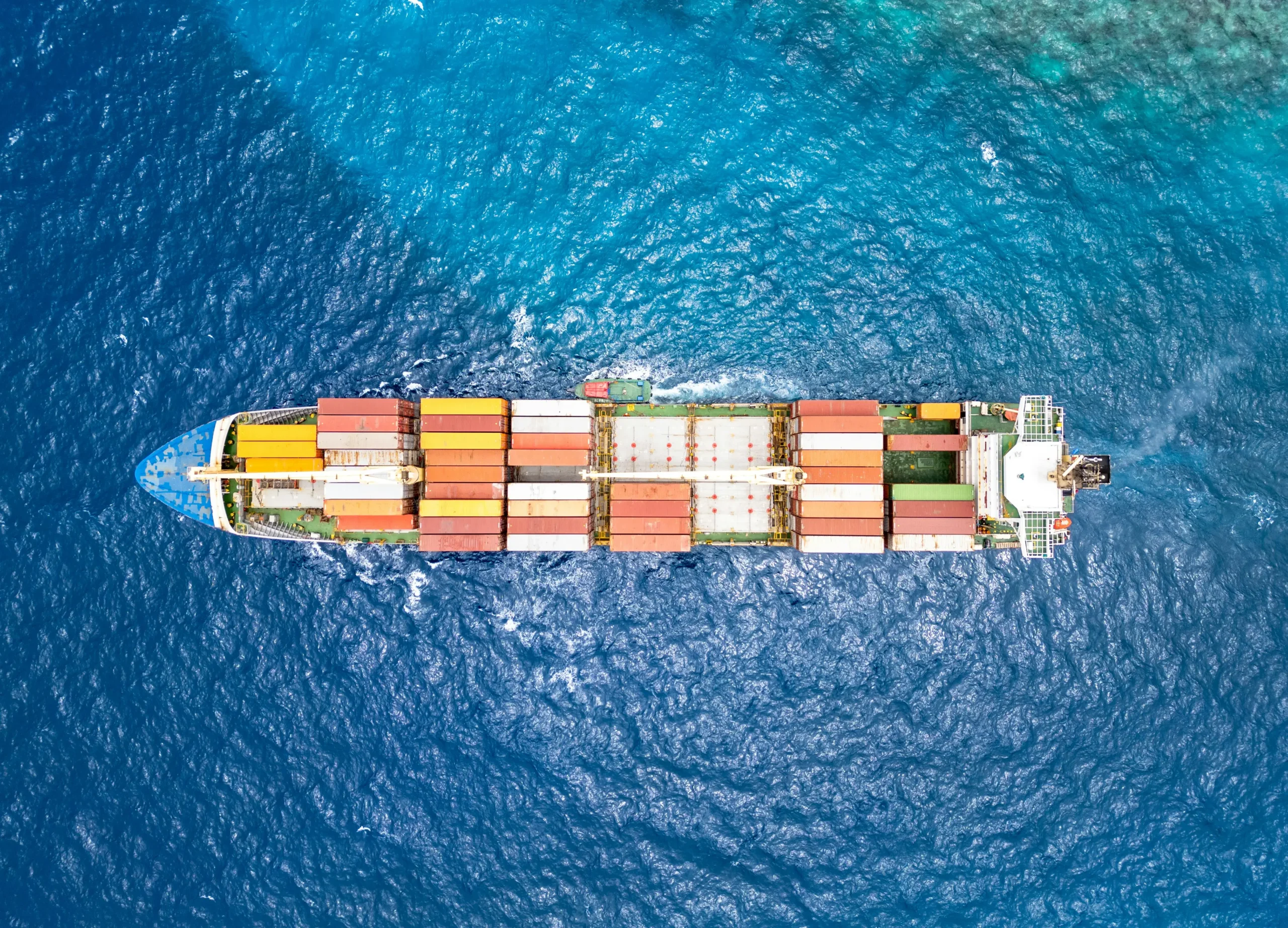 Container ship and wake at sea, featured in Ocean Tech Review's marine engineering resources